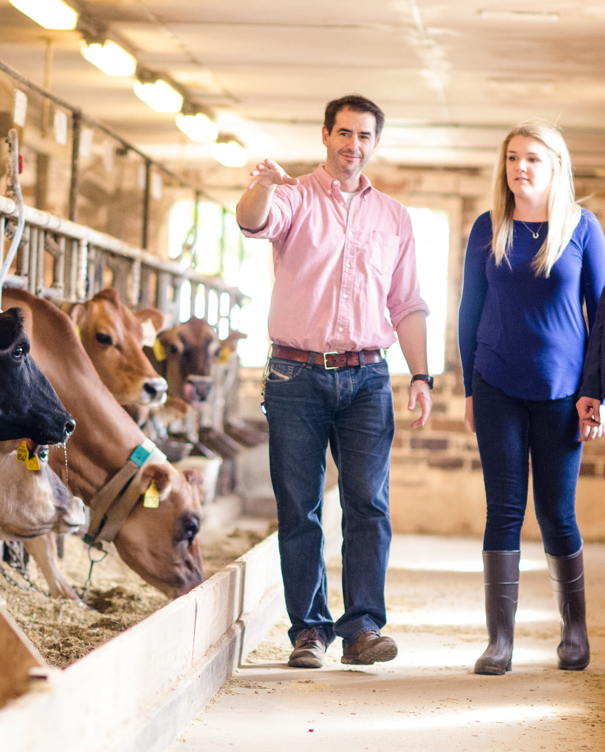 Instructor with students in dairy barn.
