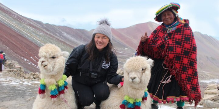 Study abroad student in mountains with al pacas